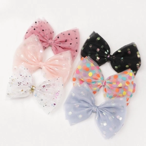 Set of six colorful polka dot and star mesh bow hair clips for girls in various pastel shades