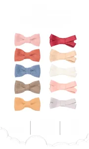 Close-up of 10-piece linen cotton bow hair clips in assorted colors for babies