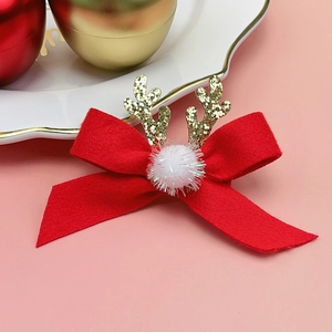 Détail d'un nœud de Noël en feutre rouge avec des bois de renne dorés à paillettes