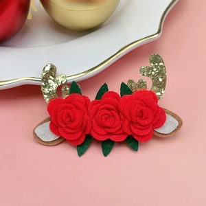 Détail de pince à cheveux de Noël avec roses en feutre rouge et bois dorés à paillettes