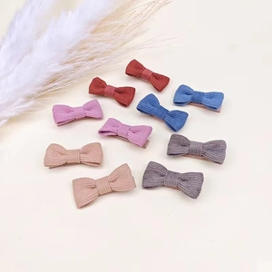 Detailed set of ten corduroy bow hair clips in various Morandi colors for babies