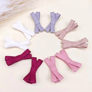 Detailed view of handmade linen bow hair clips in various pastel colors for children