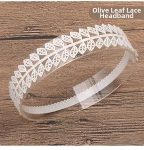 Close-up of white olive leaf lace headband with elastic band on a display stand