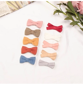 Detailed set of 11 bow hair clips in corduroy and smooth fabric for children
