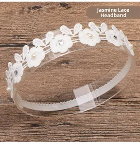 Detail of white jasmine lace headband with embroidery, pearls and rhinestones on wood