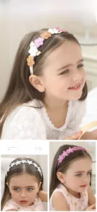 Close-up of glitter star and flower headbands for girls worn by a child model