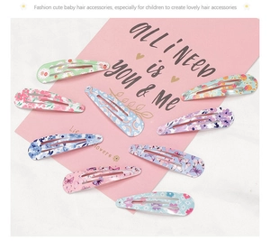 Detail of 9-piece set of colorful candy-colored BB hair clips with floral and rainbow prints