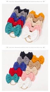 Detail of 10-piece baby nylon headband set featuring ribbed knit fabric and oversized bows
