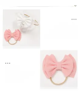 Detail of baby headband featuring soft ribbed oversized bow and seamless nylon elastic band