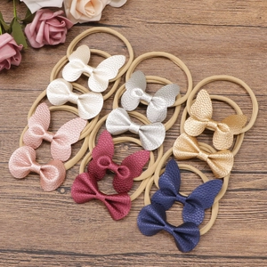 6er-Set bunte Schmetterlingsschleifen mit Litschi-Struktur auf elastischen Baby-Stirnbändern