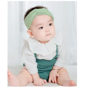 Detail of soft knit cross knot headband in mint green for babies and infants