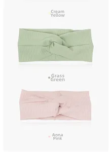 Detail shot of knitted cross knot headbands in mint green and soft pink colors