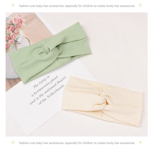 Detail of mint green and cream ribbed knit headbands with a stylish center twist knot