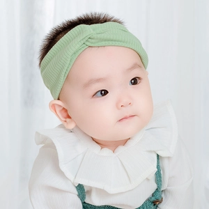 Sweet light green knitted criss-cross baby headband with ribbed texture and elastic band