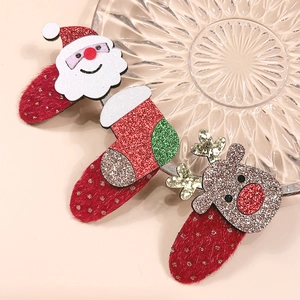 Détail de barrettes de Noël avec Père Noël, renne et chaussette en feutrine pailletée brillante