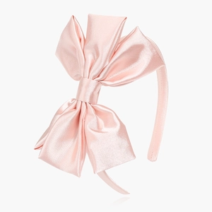 Elegant light pink satin headband with a large layered bow, professional product view