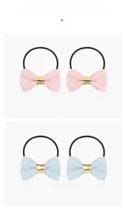 Close-up of glitter bow hair ties in crystal pink and navy blue four-piece set