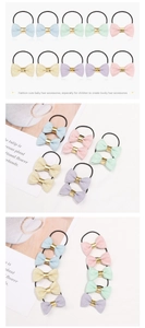 Detail of glitter bow hair ties for girls in five pastel colors with elastic bands