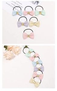 Detail of glitter bow hair ties in assorted pastel colors with gold center buckles