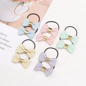 Set of 10 glitter bow hair ties for toddlers in pastel colors with elastic black bands
