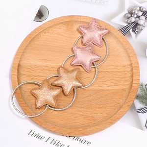Sparkly sequin star hair ties for girls in pink and gold displayed on a wooden tray