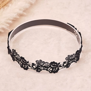 Close-up of black lace headband for girls with intricate embroidery and floral hollow pattern
