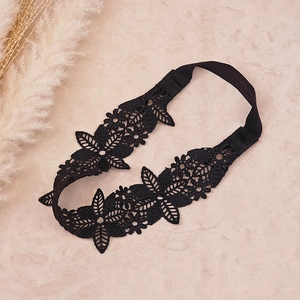 Detail of black lace hollow embroidery hairband with floral pattern and elastic band