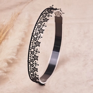 Close-up of black lace headband with star patterns on a display stand for latin dance