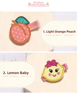Détail des barrettes brodées pêche et citron avec doublure en velours rose