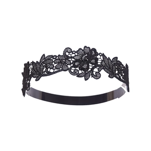 Close-up of black hollow lace headband with intricate floral embroidery details