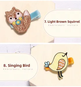 Gros plan sur les barrettes brodées motif écureuil marron et petit oiseau jaune