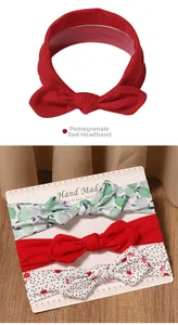 Detailed set of baby bow headbands in solid red, floral green and cherry polka dot patterns