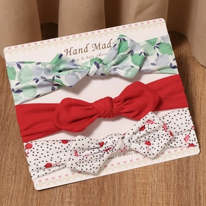 Baby headband set with floral patterns, red bow and polka dots on a display card