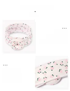 Detail showing elastic floral infant headband with soft pink doughnut shape ornament