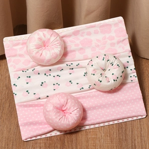 3-piece set of sweet baby donut headbands with floral and polka dot patterns on wood background