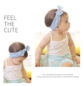 Close-up of light blue floral baby headband with a stylish knotted bow and pearl detail