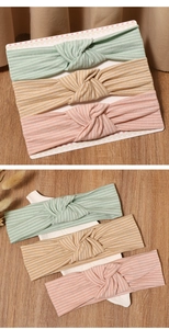 Detailed set of three ribbed knit baby headbands in mint green, mustard yellow, and pink