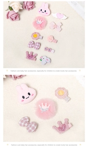 Detail view of pink rabbit hair clip set with tulle crown and embroidered bow accents