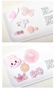 Close-up of pink bunny hair clips and lace heart accessories for young girls