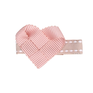 Close-up of pink ribbon heart hair clip for kids with beige stitched duckbill clip base