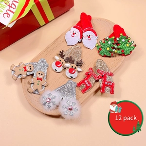 Close-up of 12-pack Christmas hair clips with sequins and reindeer horns on wood