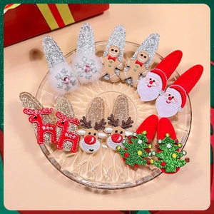 Detail of Christmas hair clips set with glitter reindeer, Santa and snowflake motifs