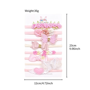 8-teiliges Baby Stirnband Set mit Schleifen, Blumen und Herzflügeln auf einer Displaykarte