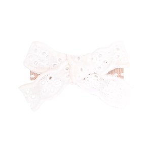 Close-up of white handmade lace bow hair clip with a ribbon-wrapped back metal clip
