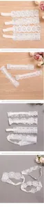 Close-up of four white lace baby headbands with delicate floral and geometric patterns