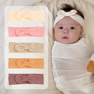 Detail showing soft modal baby headbands with wide elastic bands and cute knot bows