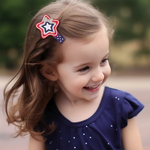 Detail shot of a toddler wearing a red white and blue star hair clip with sequin bow