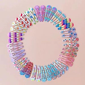 Detailed overhead view of colorful water drop BB hair clips with various cartoon patterns