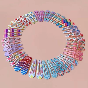 Macro shot of colorful painted metal BB hair clips with floral and animal prints