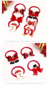 Detailed view of Christmas themed baby headbands with Santa Claus and snowman motifs